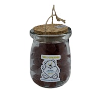 a glass jar with a teddy bear in it