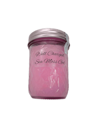 a jar with a pink candle in it